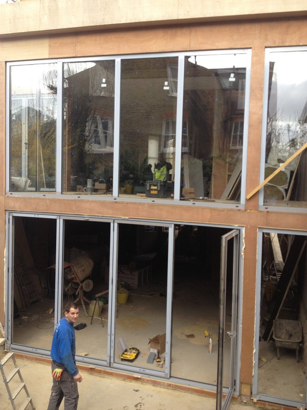 Aluminium bi-fold doors with two-storey glazing in Borehamwood